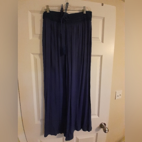 Womens navy blue flare legged pants. Never worn. Can be worn as swimsuit cover. - Picture 1 of 2